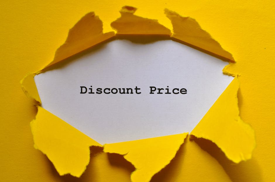 A close-up view of a torn yellow paper sheet with irregular edges, revealing a white interior section with the typed text 'Good Price' in black ink. The torn paper appears to be ripped from a larger s